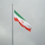 A flag flying in the wind on a cloudy day